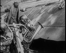 A Diver Coming up from the Sea Carrying a Tuba, 1929. Creator: British Pathe Ltd.