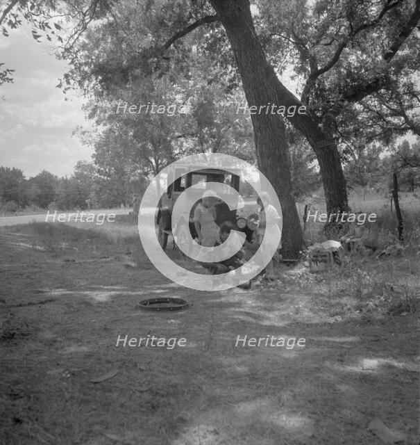 Migrant family from Oklahoma in Texas, alongside the road, 1936. Creator: Dorothea Lange.