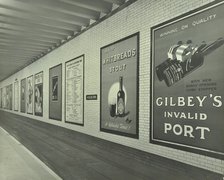 Advertisements for beer and port, Holborn Underground Tram Station, London, 1931. Artist: Unknown.