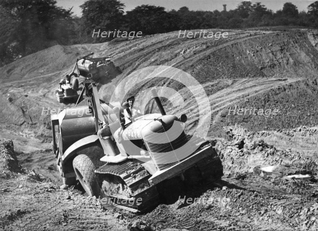 Tractor unit pulling an earth grading machine at a site near Rotherham, South Yorkshire, 1954. Artist: Michael Walters