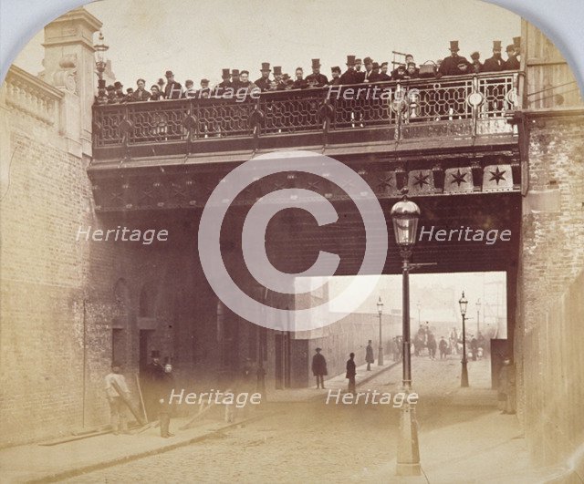 View of figures looking over the south side of Shoe Lane Bridge, City of London, 1869. Artist: Henry Dixon