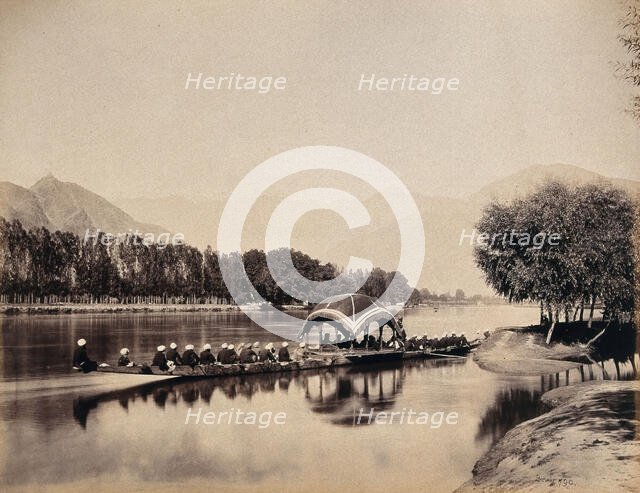 Srinagar, Kashmir: a large rowing boat proceeding along an inland waterway, c1870s. Creator: Samuel Bourne.