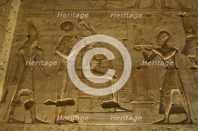 Seti I offering a statue of goddess Maat to gods Osiris..., Temple of Seti I, Abydos, Egypt (2003). Creator: LTL.