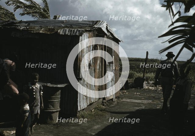 Negro migratory workers by a shack, Belle Glade, Fla., 1941. Creator: Marion Post Wolcott.