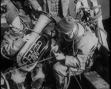 A Diver Coming up from the Sea Carrying a Tuba, 1929. Creator: British Pathe Ltd.