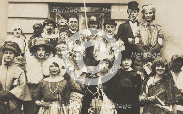 People gathered outside a building wearing various costumes, some in drag, 1924. Creator: Unknown.