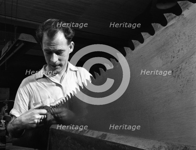 Setting the saw teeth a two metre saw blade, Sheffield, South Yorkshire, 1963. Artist: Michael Walters