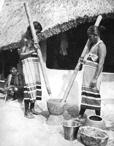 Newar women pounding grain, Nepal, 1936.Artist: Ewing Galloway