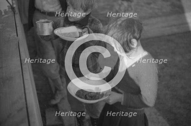 Possibly: Negroes in the lineup for food at mealtime in the camp..., Forrest City, Arkansas, 1937. Creator: Walker Evans.