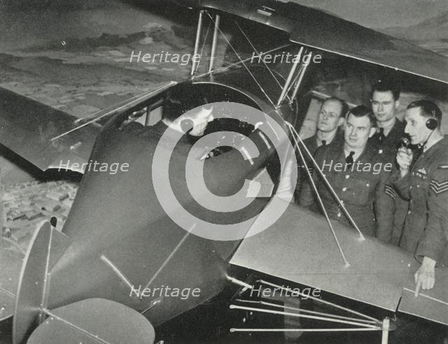 RAF personnel learning to fly in a flight simulator during the Second World War, 1941. Creator: Charles Brown.