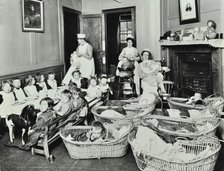 30 Albury Street; Nursey at dinner time, Children in Baskets, 1911. Creator: Unknown.