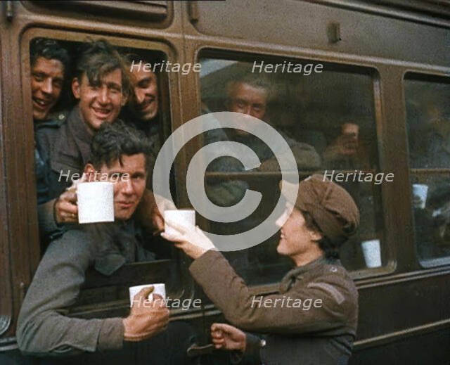 British Soldiers Receiving Food and Drink on the Train Back To Camp, 1940. Creator: British Pathe Ltd.