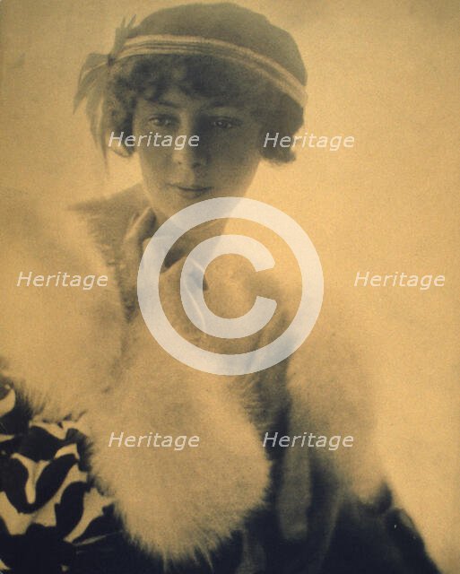 Half-length portrait of a woman wearing a fur trimmed coat, facing front, between 1900 and 1920. Creator: Unknown.
