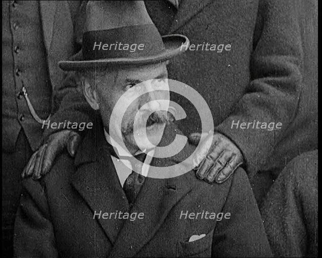 British Prime Minister Ramsay MacDonald Sitting Down. a Pair of Hands Rests on His Shoulders, 1924. Creator: British Pathe Ltd.