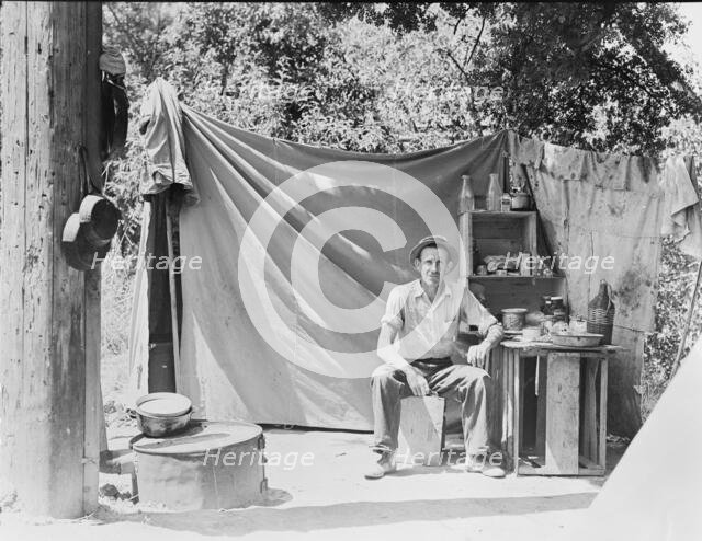 Jack Neill, "migratory fruit tramp," on banks of Pulah Creek near Winters, California, 1935. Creator: Dorothea Lange.