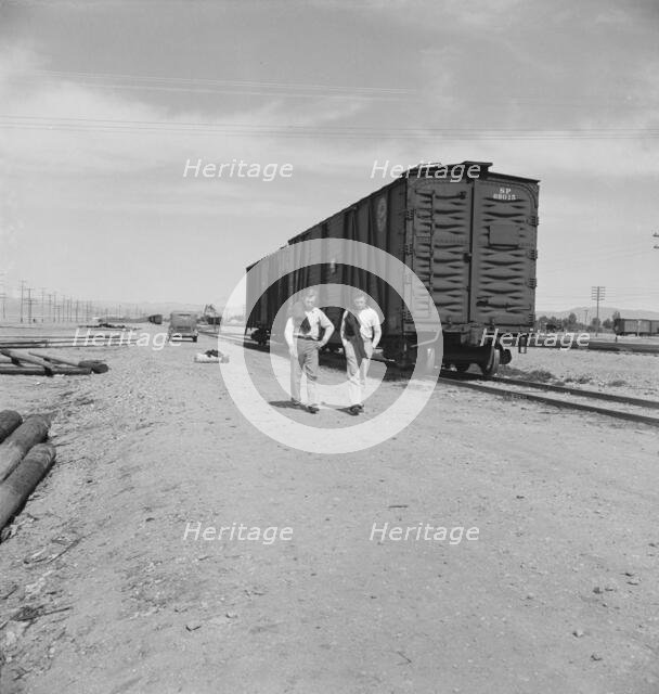 Car on siding across tracks from pea packing plant, Calipatria, Imperial Valley, 1939. Creator: Dorothea Lange.