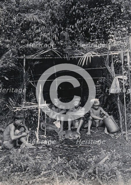 Sarawak: four Kayan hunters in their camp, c1900. Creator: Unknown.