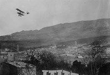 Breguet biplane, type 1910, flying over a town, possibly in Morocco, between c1910 and c1915. Creator: Bain News Service.