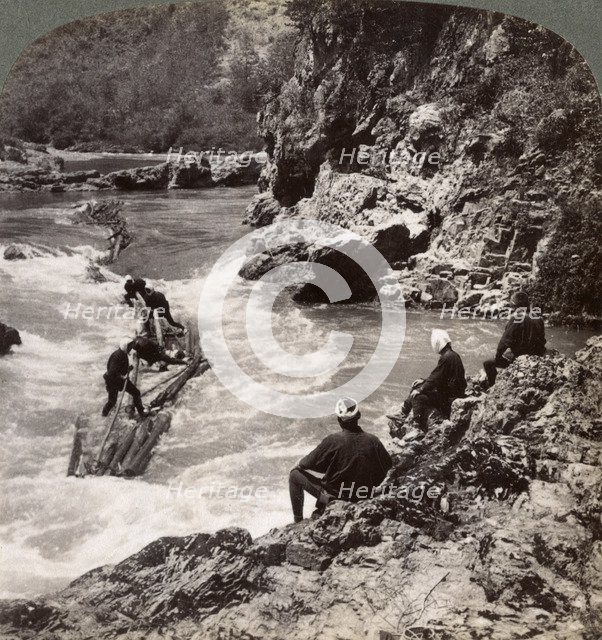 Men on a log raft, shooting the Hozu Rapids on the Katsura River, Kyoto, Japan, 1904. Artist: Underwood & Underwood