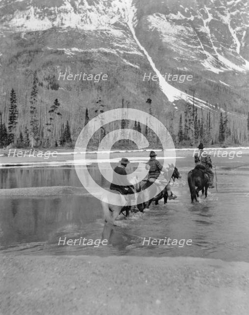 Three campers on horseback cross the Columbia River in Washington, 1903. Creator: Frances Benjamin Johnston.