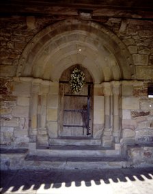View of the door of the hermitage of San Pelayo, both the door and windows are pointed, the bell …