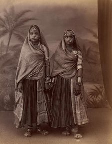 Two Hindu Women in Elaborate Jewelry, Before Studio Backdrop with Palm Trees, 1860s-70s. Creator: Unknown.