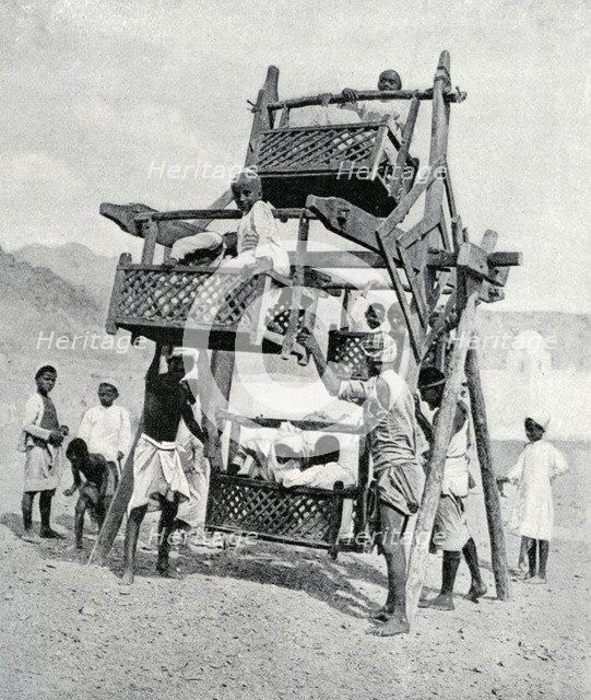 Arabian children enjoying a 'big-wheel', 1922. Artist: Unknown