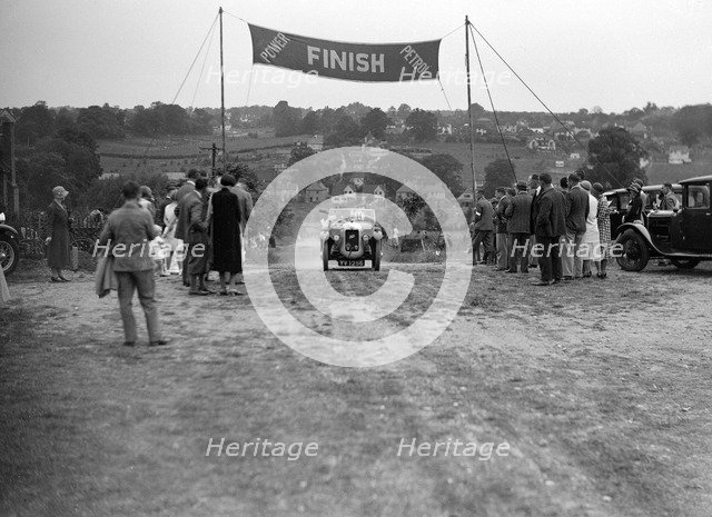 Austin Swallow of Mrs A Stanley at the finish of the Middlesex County AC Hill Climb, c1930. Artist: Bill Brunell.