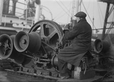 A docker operates a winching gear in London Docks, London, c1945-c1965.  Artist: SW Rawlings