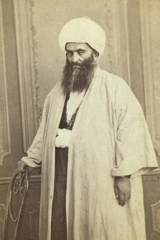Three-quarters length portrait of a mullah(?), facing left, between 1870 and 1886. Creator: Unknown.