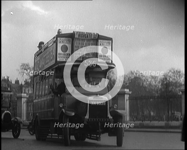 London Bus, Cars and Taxis Turning a Corner on a London Street , 1924. Creator: British Pathe Ltd.