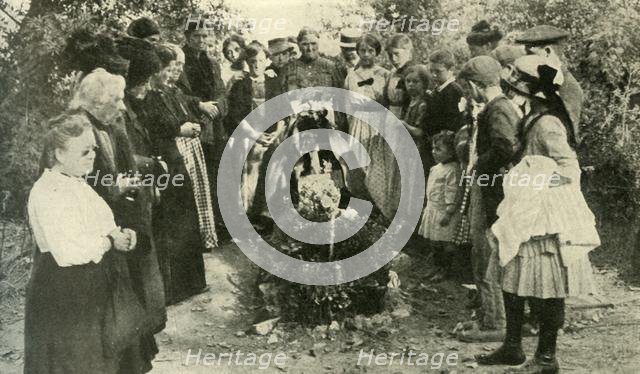 French civilians at the grave of a soldier, 1914, (c1920). Creator: Unknown.