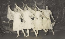 Amateur actors in drag, wearing white dresses and dancing on stage, [between 1910 and 1919?]. Creator: Unknown.