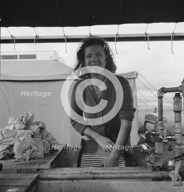 Young migrant girl makes use of facilities..., Merrill FSA camp, Klamath County, Oregon, 1939. Creator: Dorothea Lange.