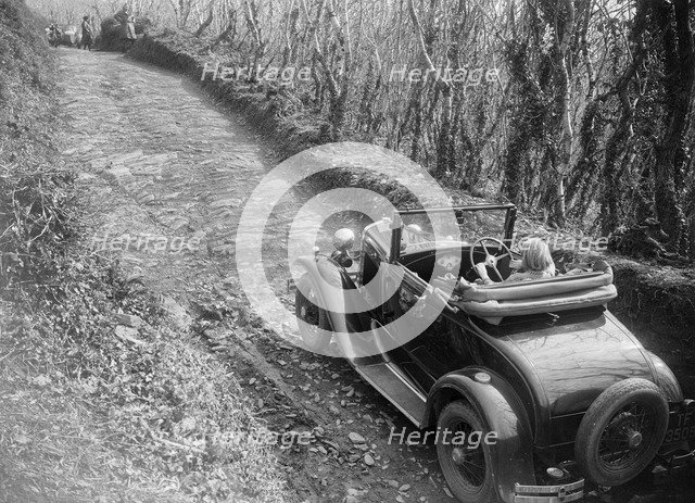Kitty Brunell driving a 1930 Ford Model A 2-seater, 1931. Artist: Bill Brunell.