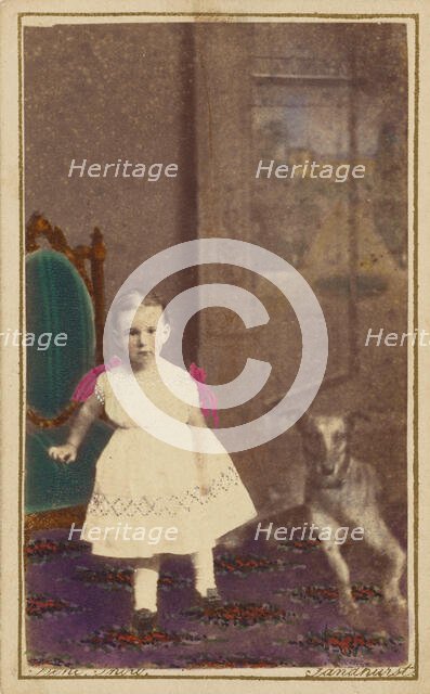 Unidentified little girl standing with a dog on the floor next to her, 1865-1875. Creator: Bent.