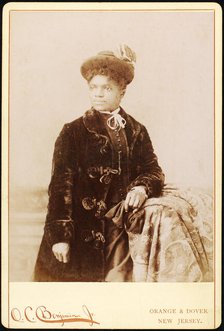 Studio portrait of woman wearing hat, and velvet coat, c1880-c1889. Creators: O.C. Benjamin, Unknown.