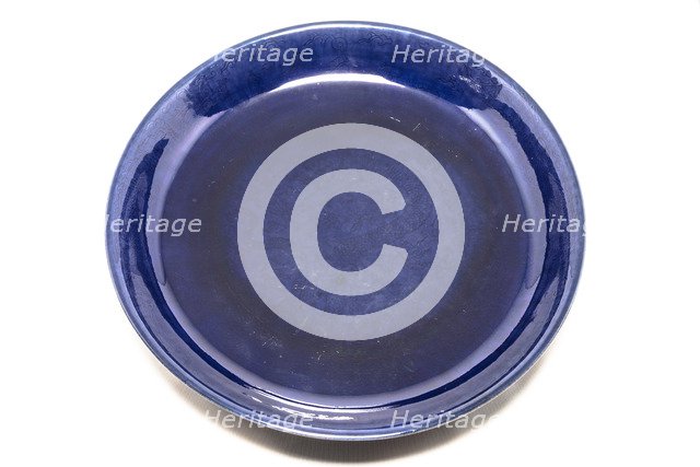 Deep aubergine dish with carved dragons chasing flaming pearl, 1662-1722. Artist: Unknown.