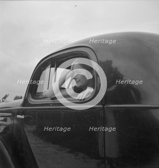 Untitled, 1935-1942. [Woman in a car]. Creator: Unknown.