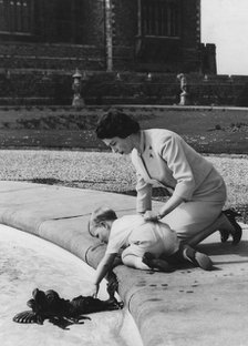 Queen Elizabeth II and Prince Andrew in the grounds of Windsor Castle, early 1960s. Artist: Unknown
