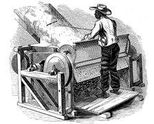 Saw gin for cleaning cotton being operated by barefoot black labourer, southern USA, 1865. Artist: Unknown