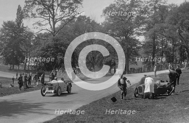 MG J2 passing the crashed Austin 7 of B Sparrow, Donington Park Race Meeting, Leicestershire, 1933. Artist: Bill Brunell.