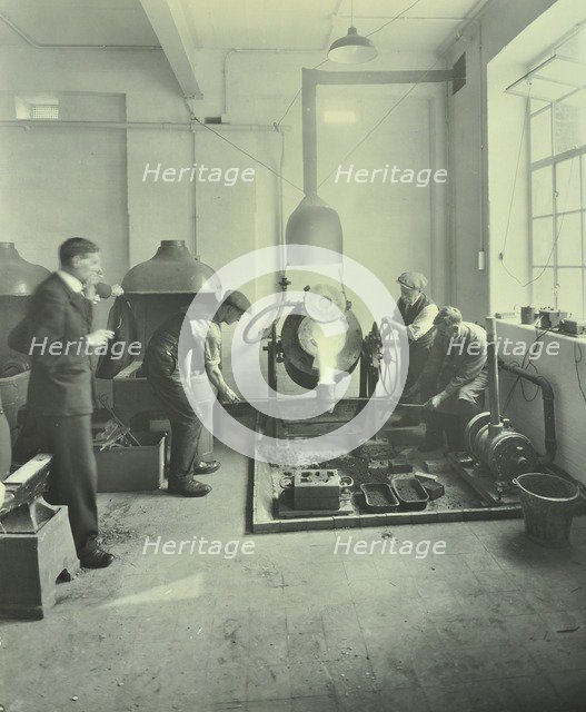Men pouring molten metal in a foundry, School of Engineering and Navigation, London, 1931. Artist: Unknown.