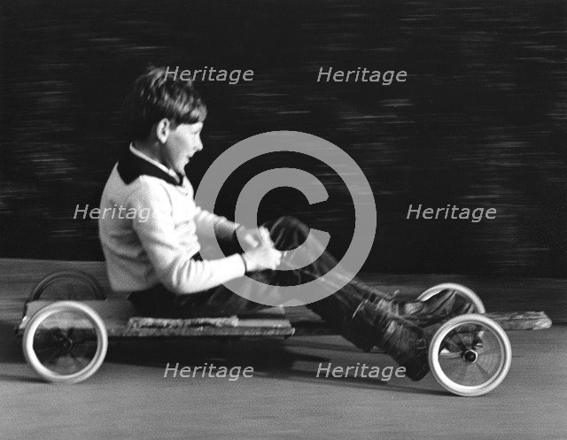 Boy driving a home-made go-kart, Horley, Surrey, 1965.