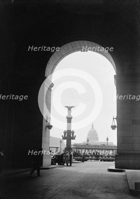 U.S. Capitol - View Through Arch At Union Station, 1917.  Creator: Harris & Ewing.
