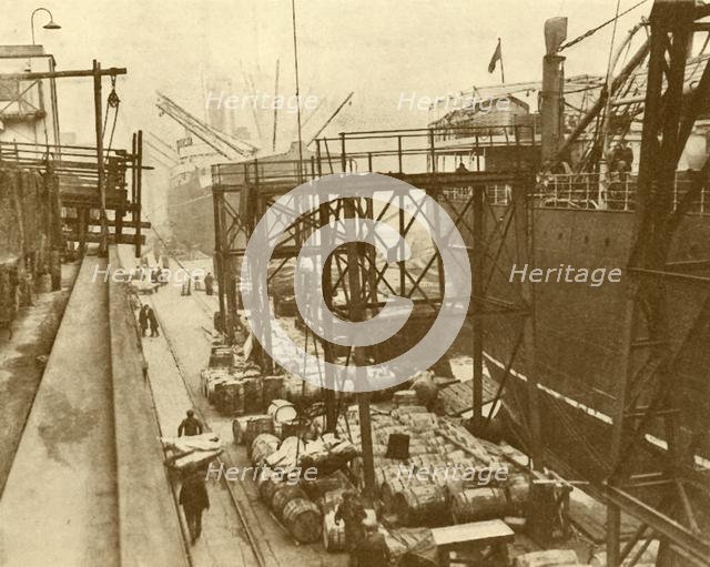 'Unloading Foodships at the Royal Albert Docks, London', c1930. Creator: Unknown.