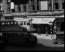 Exterior of Stewards Restaurant and London Traffic. Sign on the Side of a Bus Reads..., 1931. Creator: British Pathe Ltd.