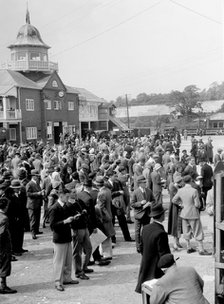 People attending a motor racing event at Brooklands. Artist: Bill Brunell.