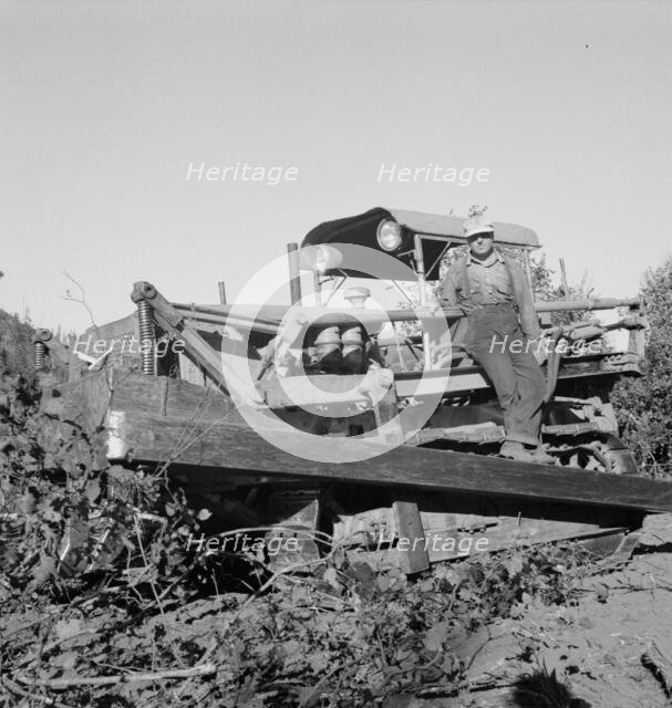 Possibly: Bulldozer raises and pushes stump on cut-over farm, Lewis County, Western Washington, 1939 Creator: Dorothea Lange.