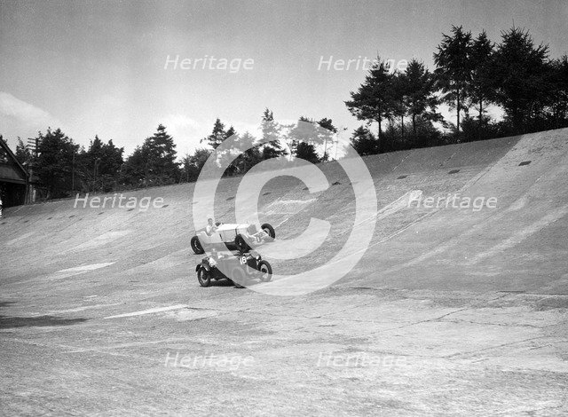 Invicta and Austin Ulster racing on the Members Banking at Brooklands. Artist: Bill Brunell.
